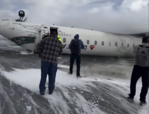 people standing next to a plane